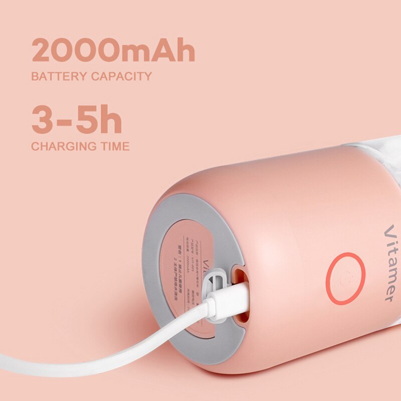 Vitamer rechargeable personal blender in pink being charged with USB cable showing 2000mAh battery capacity