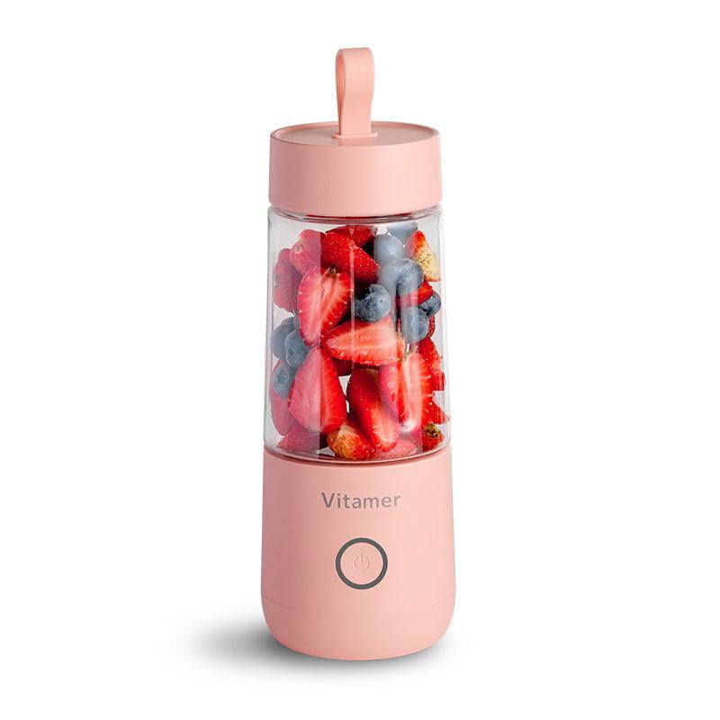 Vitamer rechargeable personal blender in pink with fresh strawberries and blueberries inside